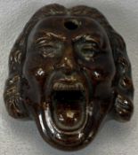 EARLY 19TH CENTURY TREACLE GLAZED INKWELL, depicting an open mouthed Sir Robert Walpole, 7.5 x 6.