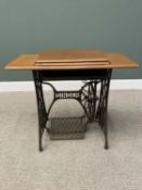 SINGER TREDLE SEWING MACHINE TABLE, having a foldover oak worktop and cast iron base, sewing machine