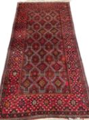 EASTERN WOOLEN RUG, red ground with diamond central pattern block, triple wide and slim bordered