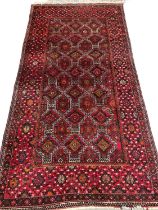 EASTERN WOOLEN RUG, red ground with diamond central pattern block, triple wide and slim bordered