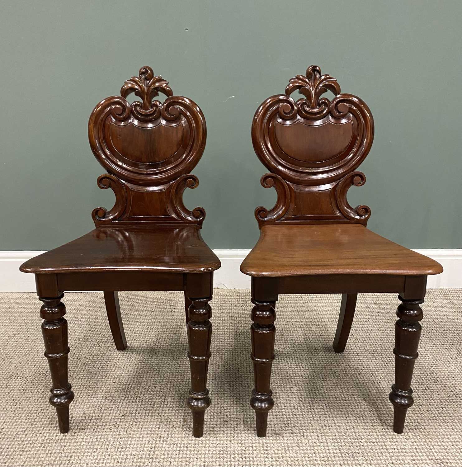 VERY NEAR PAIR OF VICTORIAN MAHOGANY HALL CHAIRS, having carved leaf crest and scrolled shield panel