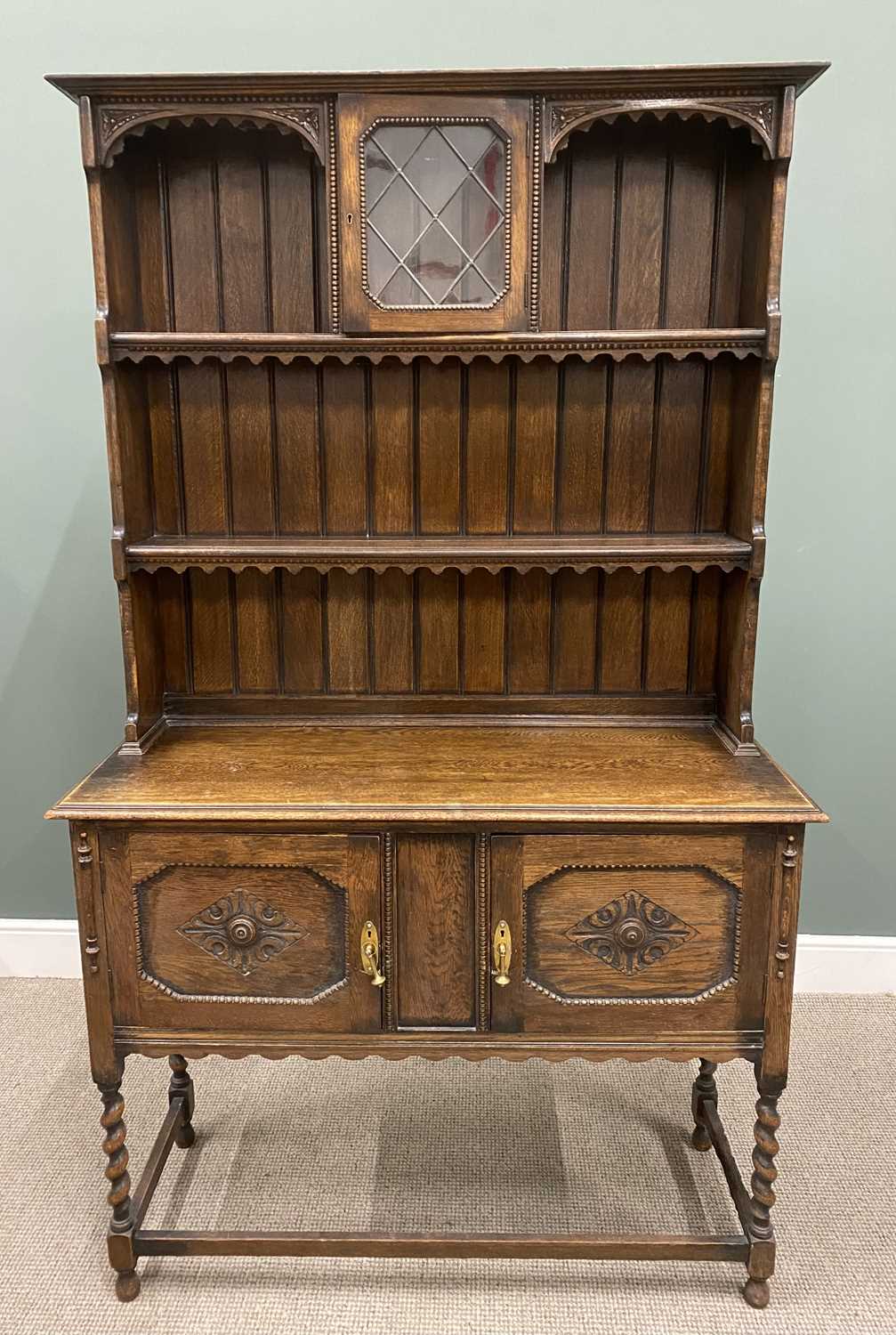 VINTAGE OAK JACOBEAN-STYLE DRESSER with upper central leaded glazed door to the shaped sided rack,