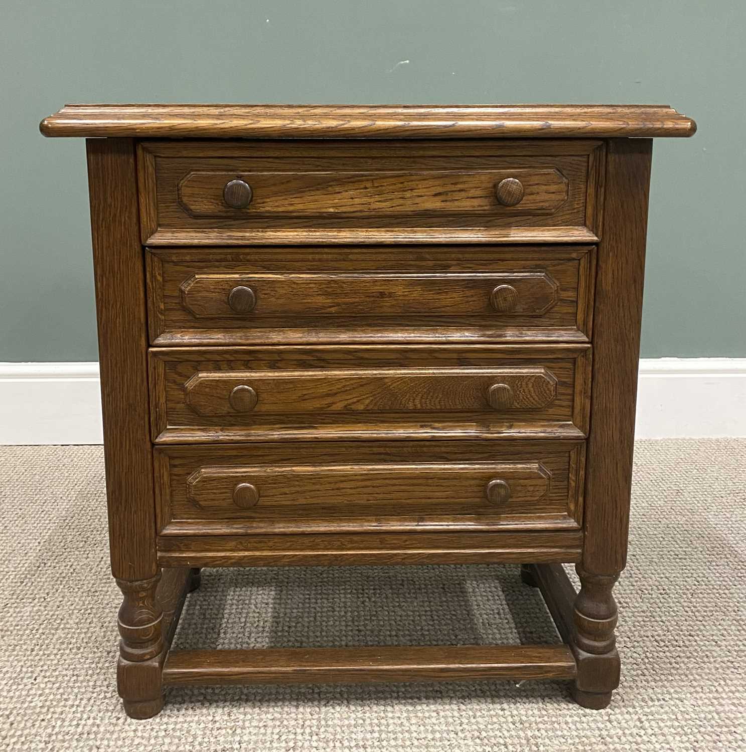 NEAT REPRODUCTION OAK CHEST OF FOUR DRAWERS with turned wooden knobs, on turned and block supports