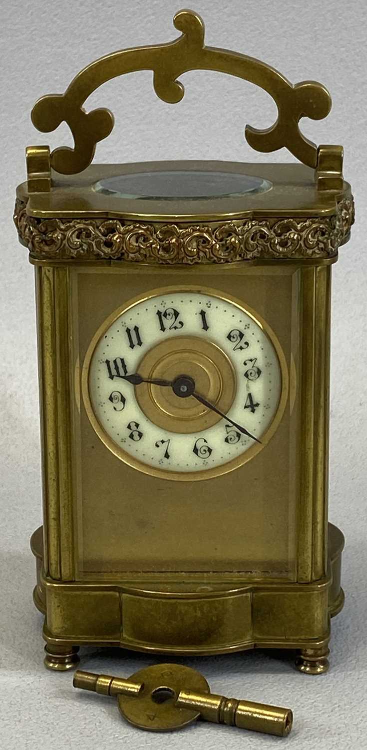 VINTAGE FRENCH BRASS CARRIAGE CLOCK with shaped detail to the upper and lower case and the swing