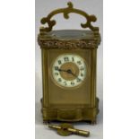 VINTAGE FRENCH BRASS CARRIAGE CLOCK with shaped detail to the upper and lower case and the swing