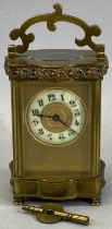 VINTAGE FRENCH BRASS CARRIAGE CLOCK with shaped detail to the upper and lower case and the swing