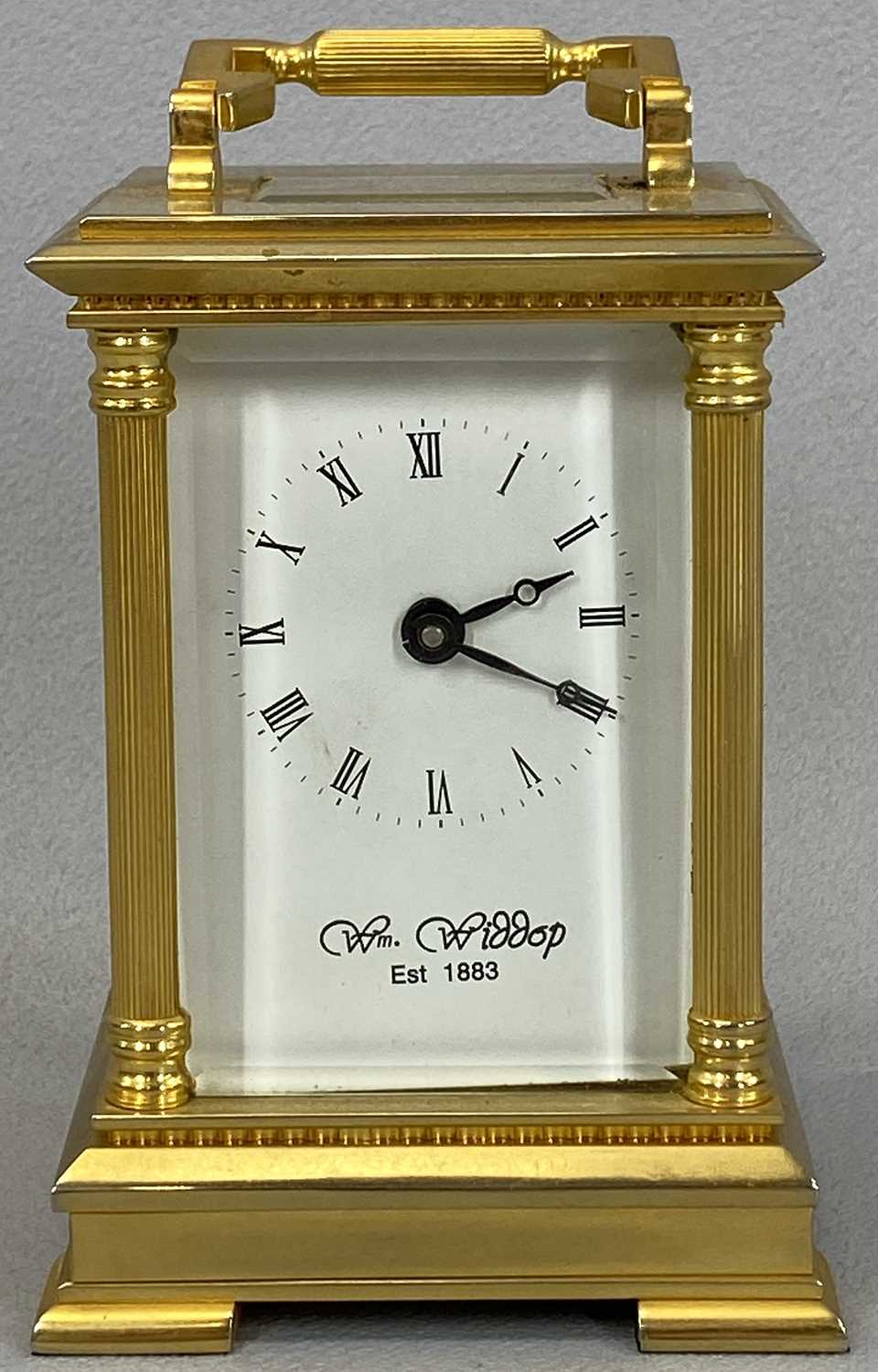 WILLIAM WIDDOP MODERN BRASS CASED CARRIAGE CLOCK WITH KEY, the white dial set with Roman numerals in