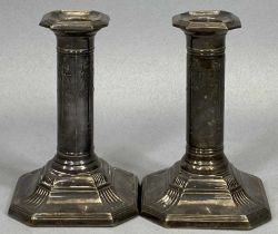 TWO MATCHING PATTERN CANDLESTICKS both having ribbon swag detail to the columns on ribbed stepped