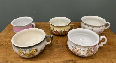 FIVE VICTORIAN & LATER POTTERY CHAMBER POTS, having floral and other decorations Provenance: private