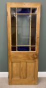 SINGLE STRIPPED PINE DOOR with upper central clear glass panel and stained glass surround, having