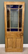 SINGLE STRIPPED PINE DOOR with upper central clear glass panel and stained glass surround, having