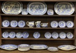 FORTY-PIECE WILLOW PATTERN DRESSER SET, comprising six meat platters, 45cms across the largest, 2
