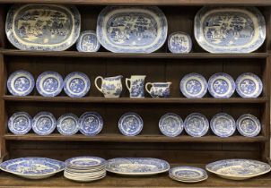 FORTY-PIECE WILLOW PATTERN DRESSER SET, comprising six meat platters, 45cms across the largest, 2