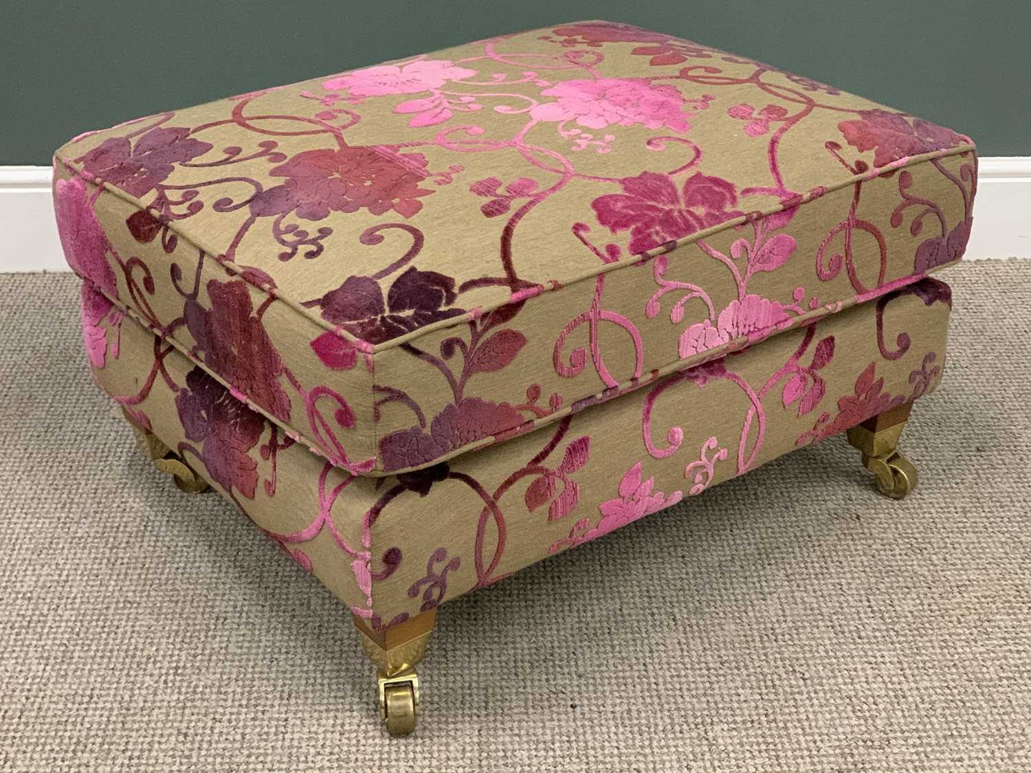 MODERN OVERSIZED UPHOLSTERED FOOTSTOOL on brass castors, 47cms H, 83cms W, 67cms D Provenance: