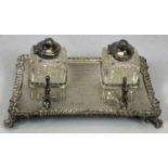 EDWARD VII SILVER INKSTAND of shaped rectangular form, with gadrooned border and scroll feet, with