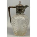 VICTORIAN SILVER MOUNTED CUT GLASS CLARET JUG, the hinged cover with vase form finial, the collar