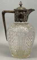 VICTORIAN SILVER MOUNTED CUT GLASS CLARET JUG, the hinged cover with vase form finial, the collar