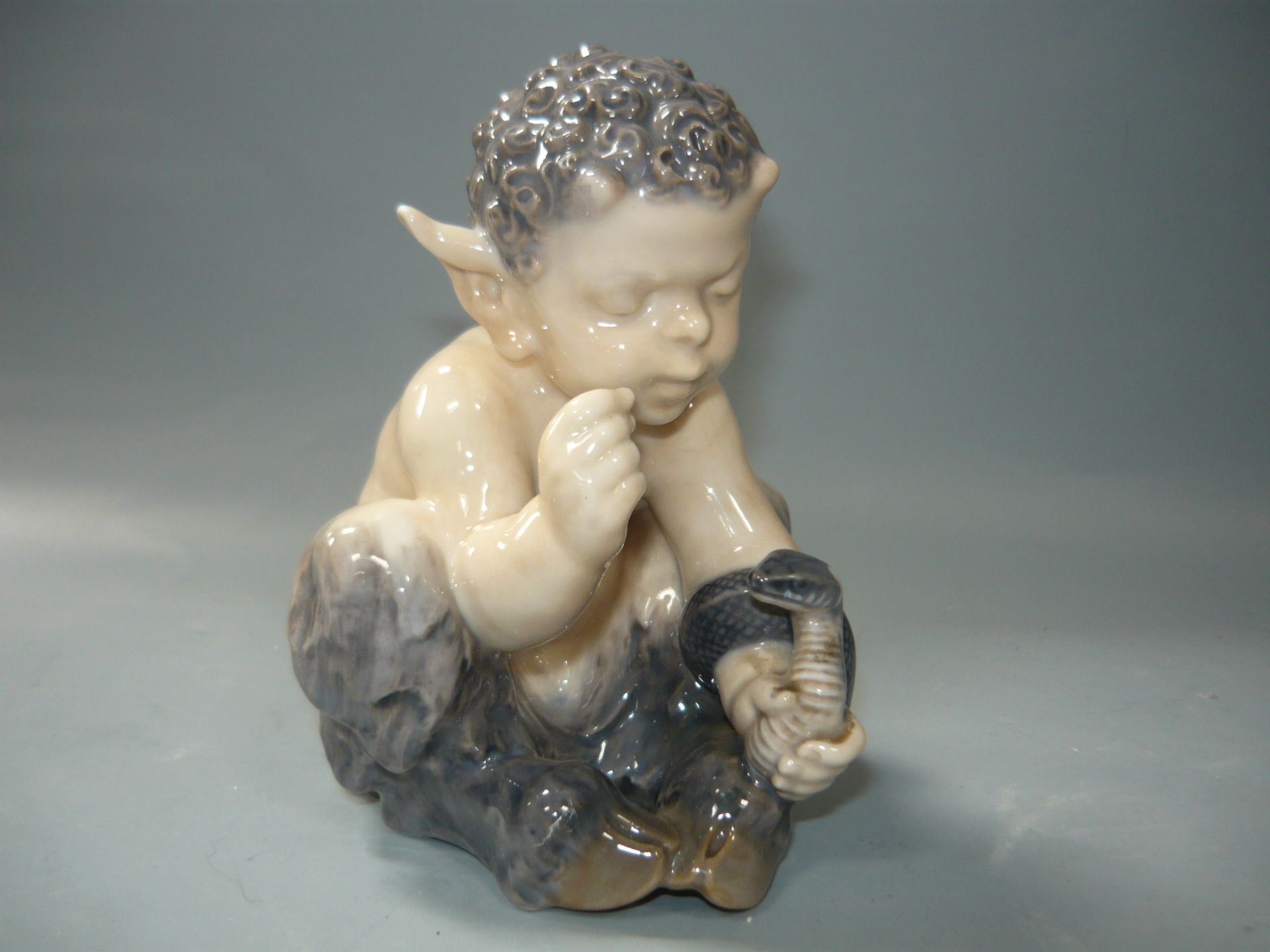 Royal Copenhagen. Faun mit Schlange. Erste Wahl. Antik 1897-1922. H. 12cm. //English: Satyr with