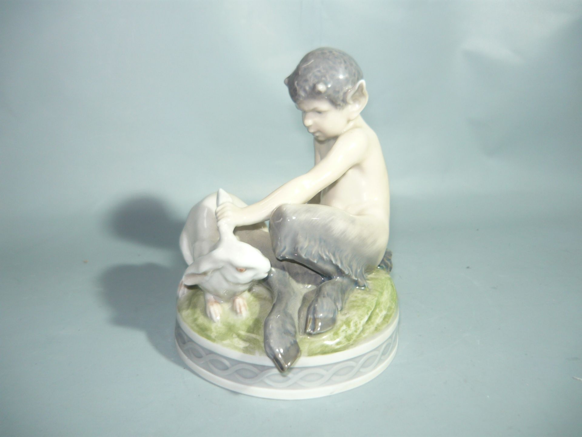 Royal Copenhagen. Sitzender Faun mit weissem Hasen. Erste Wahl. H. 13cm. //English: Royal