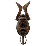 Dekorative Gesichtsmaske mit Zickzack-Hörnern, Elfenbeinküste, Holz geschnitzt und dunkel gefärbt, L