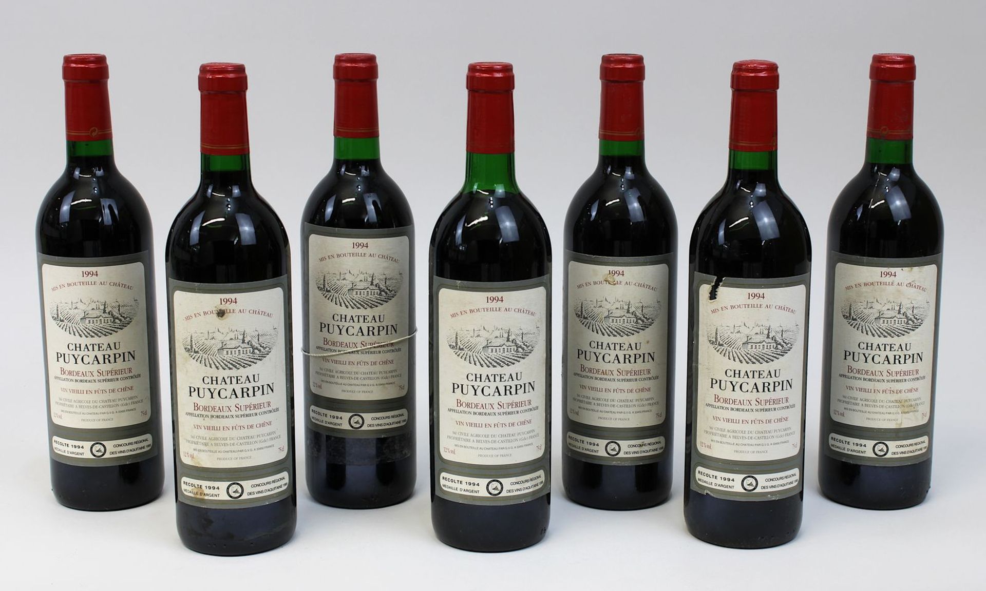 Sieben Flaschen 1994er Chateau Puycarpin, Bordeaux Supérieur, Füllhöhe: Halsansatz und gute