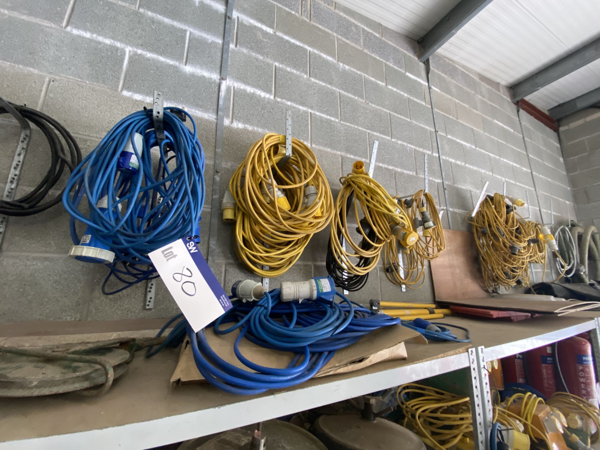 Assorted 110V & 240V Extension Cables, as set out on wall rackPlease read the following important