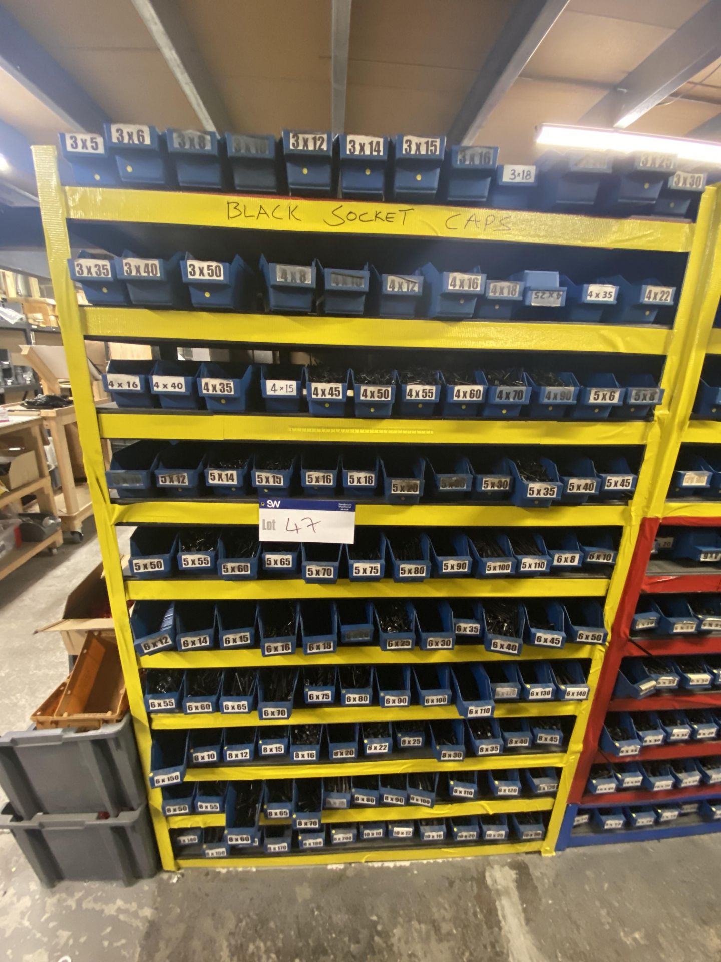 Quantity of Self Colour All Black Socket Caps, with plastic stacking bins, as set out on one bay