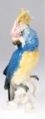 Figur "Kakadu auf Ast sitzend", Karl Ens, polychrom bemalt, Haube bestoßen, H. 27 cm