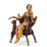 Bronze-Figur "Orientalische Dame auf Armlehnstuhl sitzend", 2-teilig, Nachguß, farbig und messingfa