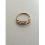 9ct gold garnet and white opal five-stone set ring, gross weight 1.3g size J. Shipping Group (A).