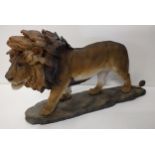 Large nicely detailed composite lion figure on plinth H:26 x L:47 cm. Shipping Group (A).
