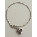 Silver heart-shaped locket on chain. Shipping Group (A).