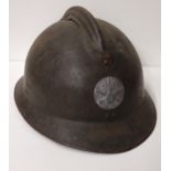 WWI French Adrian helmet featuring artillery insignia with liner and strap. Shipping Group (A).