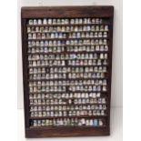 Over (200) collectable thimbles in large display case measuring H:72 x W:48 cm. Collection only.