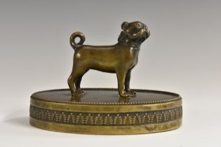 A 19th century French dark patinated bronze desk weight, as a pug, oval base with anthemion