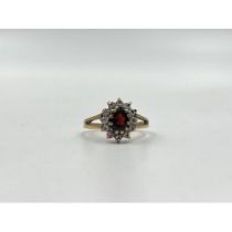 9ct gold garnet and cubic zirconia halo ring, size N. Shipping Group (A).