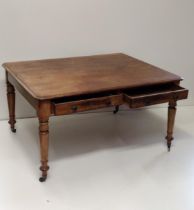 Antique oak dining table having having two drawers on both sides, and raised on turned legs with