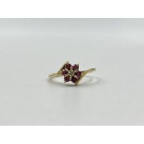 9ct gold ruby and diamond floral dress ring, size N. Shipping Group (A).