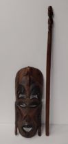 Wooden tribal mask together with a carved ceremonial stick. Collection only.