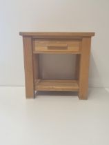 Modern light oak occasional table having central drawer and undershelf. Measuring H:61 x W:62 x D:45