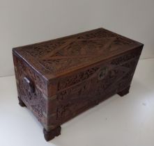 A substantial and highly carved wooden chest of Oriental origin. Measuring H:60 x L:104 x D:57 cm.