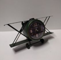 Desk clock in the form of a bi-plane. Measuring  31cm overall width. Collection only.