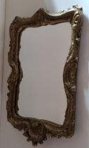 Ornate gilt framed wall mirror, approx. H:54 x W:37 cm. Collection only.