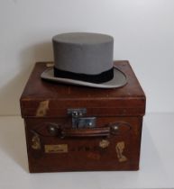 An antique Harrod's leather hat box with a grey top hat. Shipping Group (B).