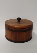 A vintage wooden and metal banded storage container, 28 cm in diameter. Shipping Group (B).