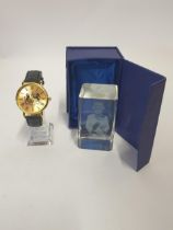 Quartz wrist watch together with a hologram Elizabeth II glass paperweight. Shipping Group (A).