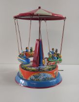 German mechanical clockwork lithographed tinplate fairground carousel toy by Josef Wagner. Working