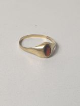 9ct gold oval garnet signet ring, size P. Shipping Group (A).