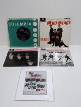 4 Beatles singles and framed poster. Shipping Group (A).