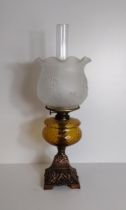 Antique oil lamp having amber glass reservoir and milk glass shade. Collection only.